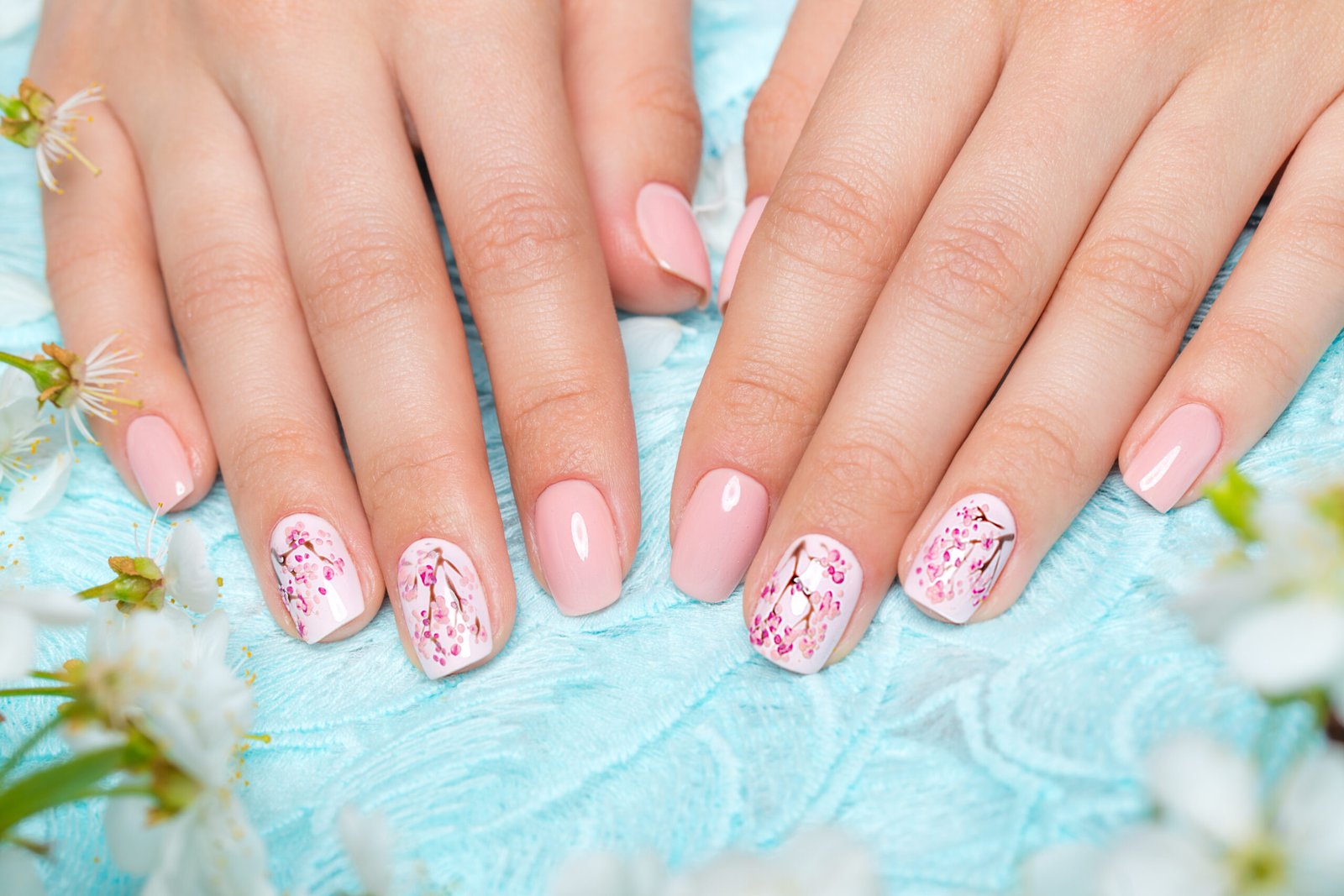 Spring manicure for the bride in gentle tones with flowers. Nail Design.